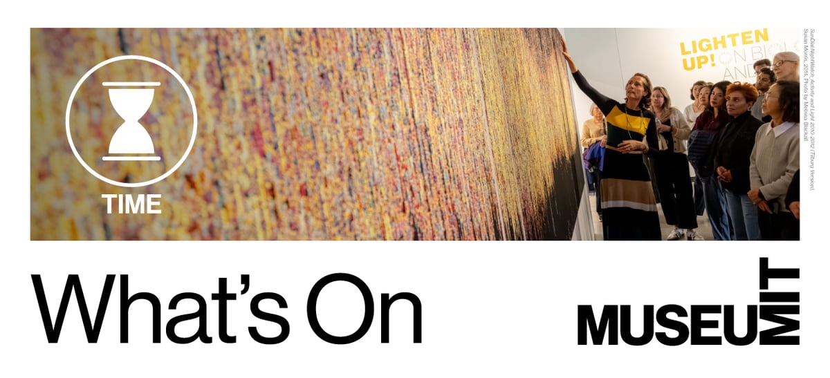 Visitors look at colorful woven tapestry in our Lighten Up! On Biology and Time exhibition. 